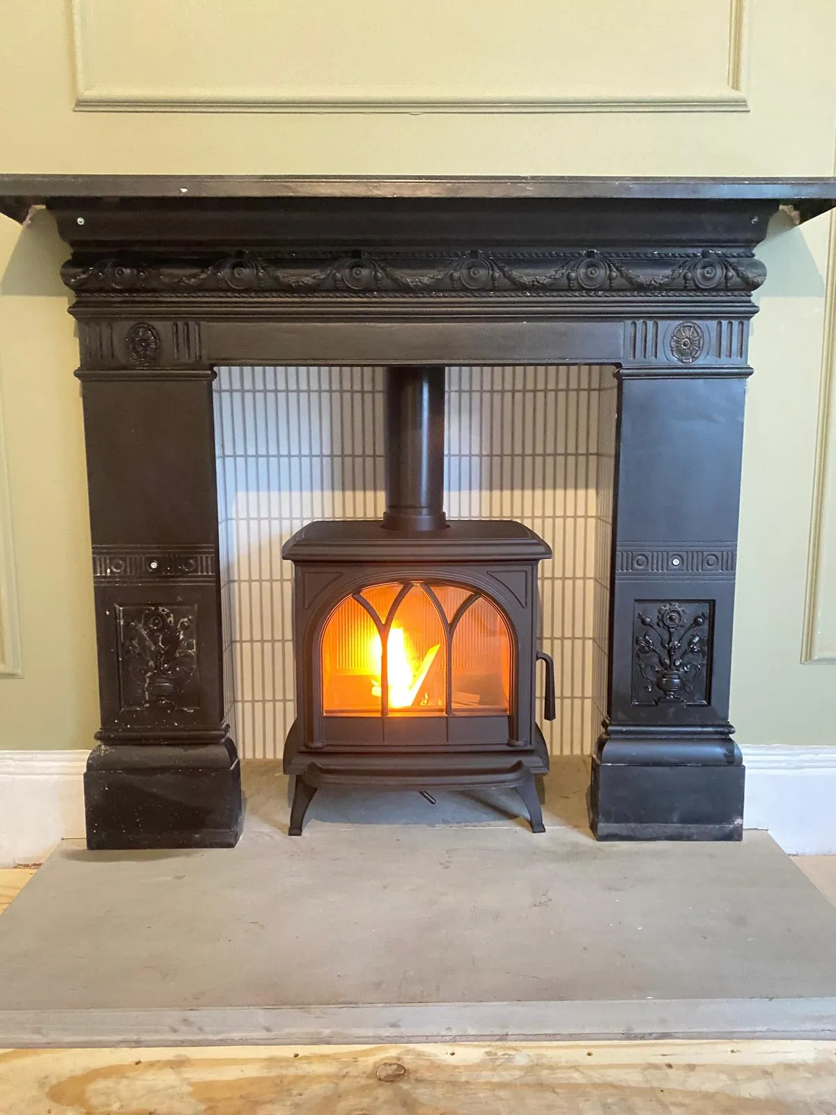 Traditional stove in ornate Victorian fireplace