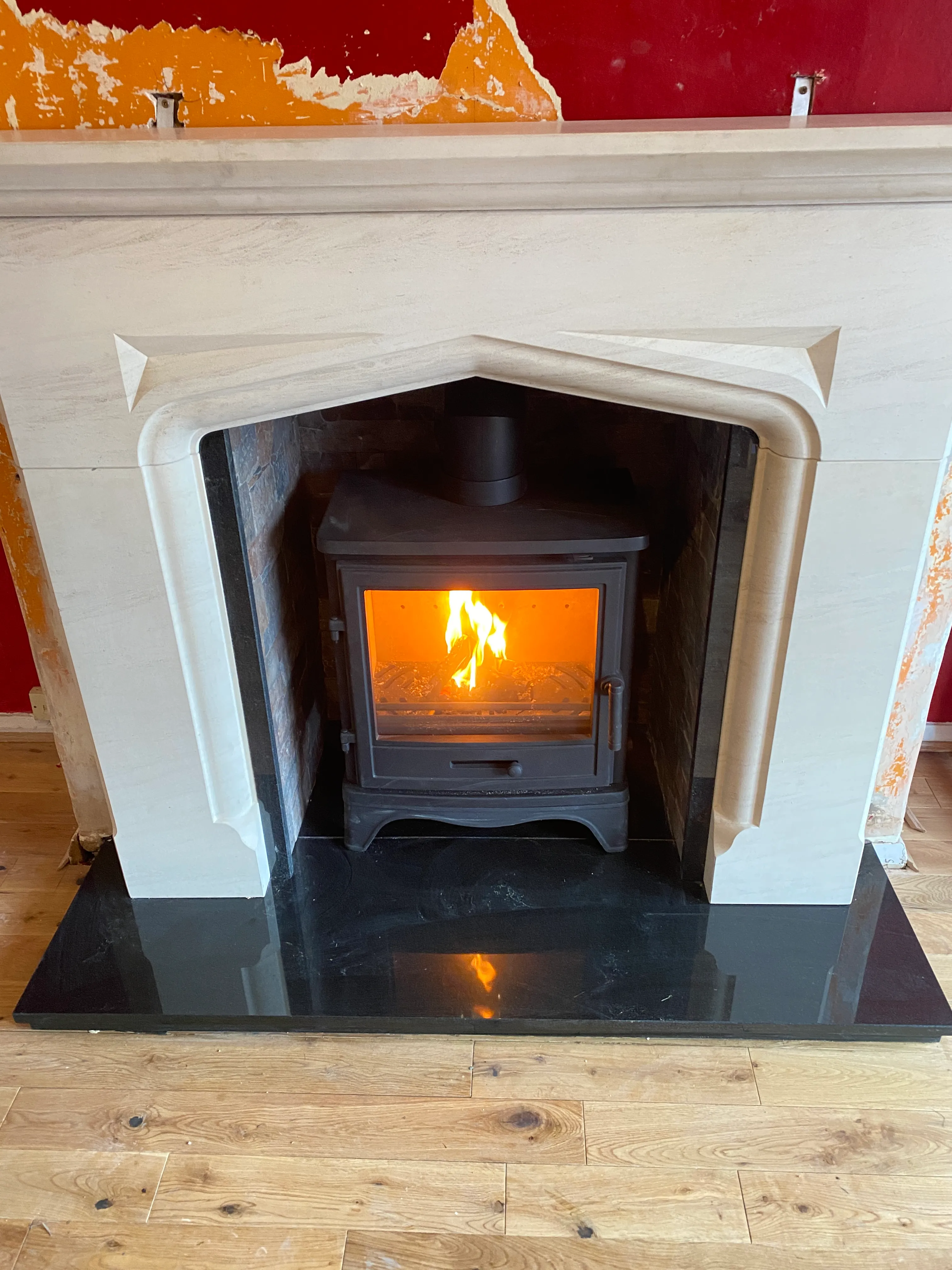 Inset stove in a stone mantel with slate hearth